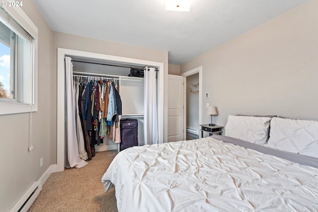 bedroom with carpet flooring, baseboards, a baseboard heating unit, and a closet