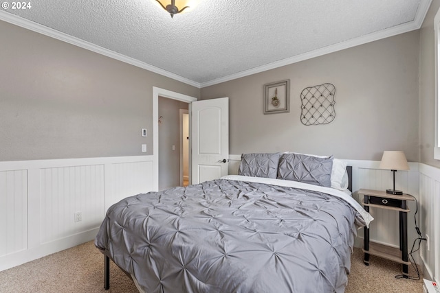 carpeted bedroom with ornamental molding and a textured ceiling