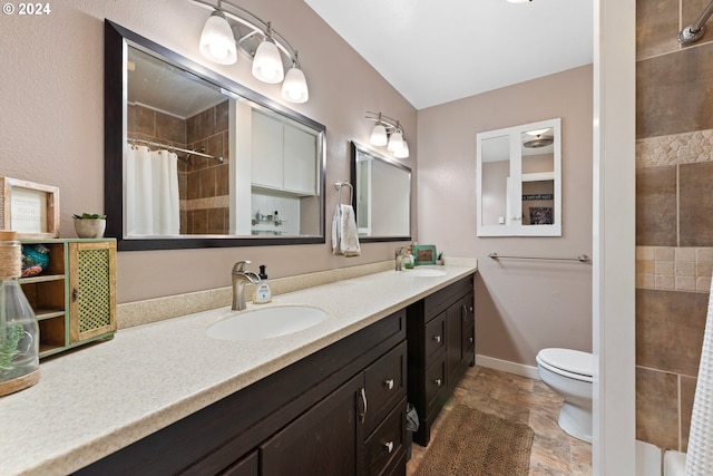 bathroom with vanity, vaulted ceiling, a shower with shower curtain, and toilet