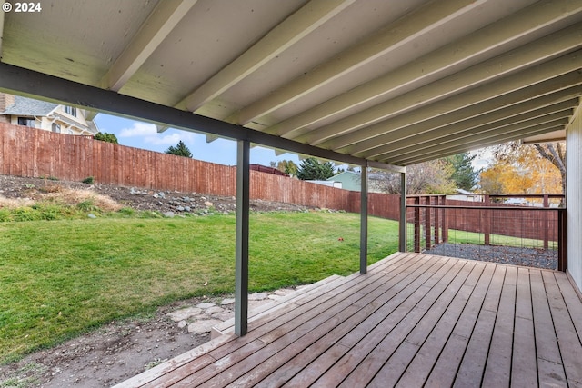 wooden deck featuring a lawn