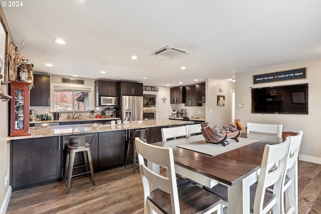 dining area with hardwood / wood-style flooring and sink