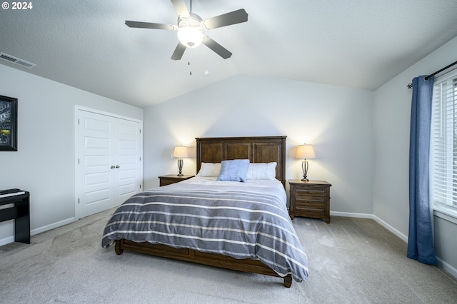 carpeted bedroom featuring a closet, ceiling fan, and lofted ceiling