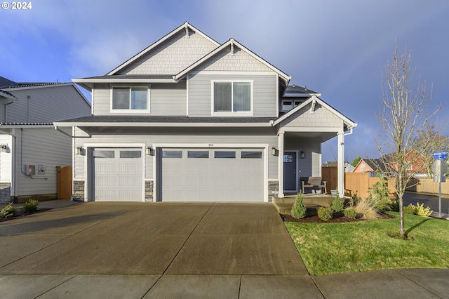 craftsman-style house featuring a front yard and a garage