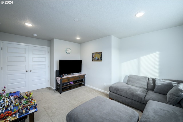 carpeted living room featuring a textured ceiling