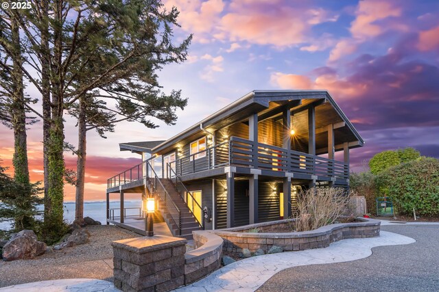 view of front of house with stairs and a deck