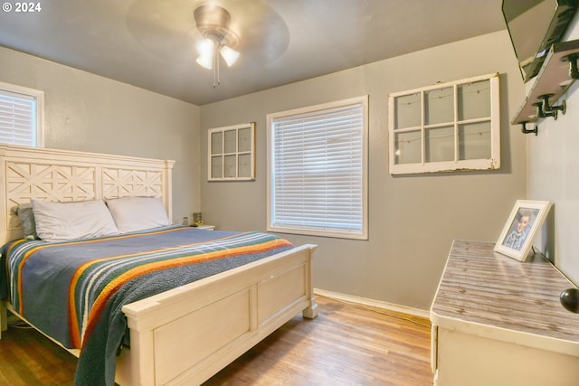 bedroom with ceiling fan and light hardwood / wood-style flooring