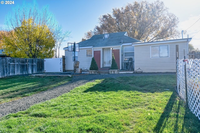 back of house with a yard