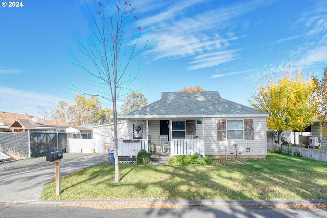 bungalow-style house with a porch and a front lawn