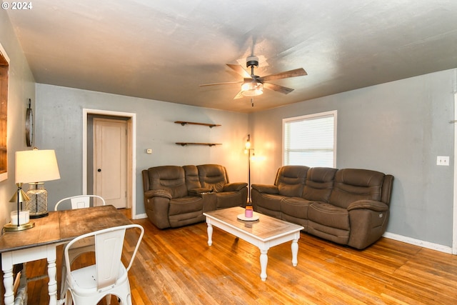 living room with ceiling fan and light hardwood / wood-style floors