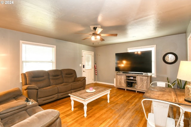 living room featuring ceiling fan and light hardwood / wood-style flooring