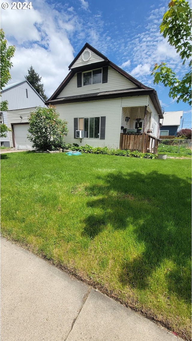 view of front of property featuring a front yard and a garage