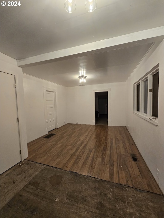 spare room with dark wood-type flooring