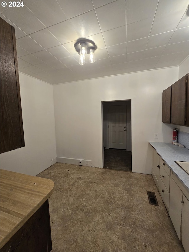 kitchen featuring dark brown cabinetry