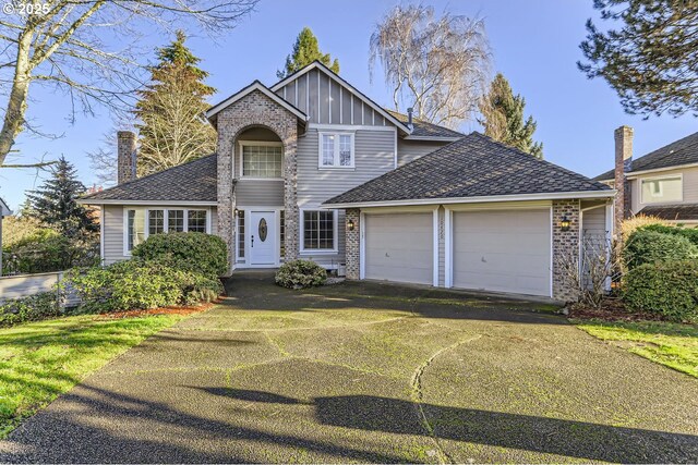 view of front of home with a garage and a front lawn