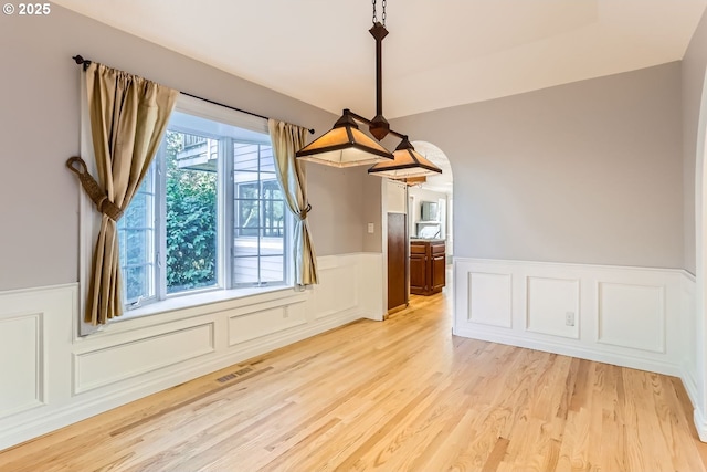 10420 SW 153rd Ave, Beaverton, OR 97007 - unfurnished dining area with a wainscoted wall, light wood-type flooring, and a decorative wall