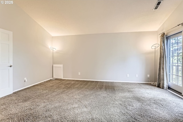 unfurnished room with carpet flooring and vaulted ceiling