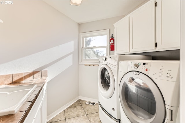 10420 SW 153rd Ave, Beaverton, OR 97007 - washroom with separate washer and dryer, cabinet space, baseboards, and light tile patterned floors