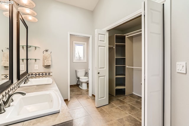 bathroom with vanity, toilet, and tile patterned flooring