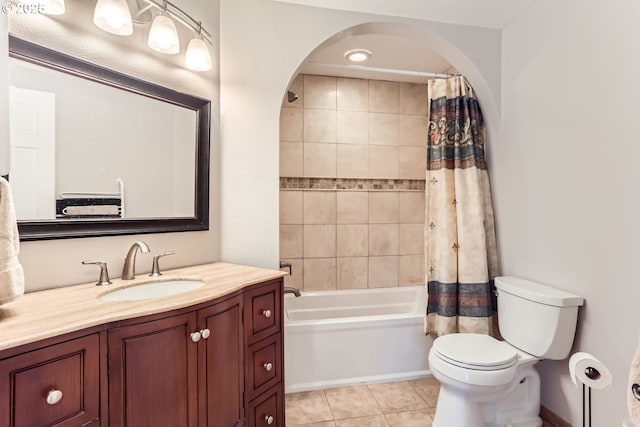 full bathroom featuring vanity, tile patterned floors, toilet, and shower / tub combo with curtain