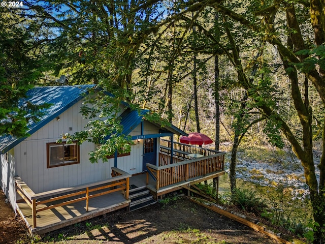 view of front of house with a deck with water view