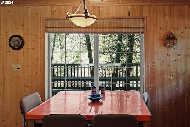 dining room with wooden walls