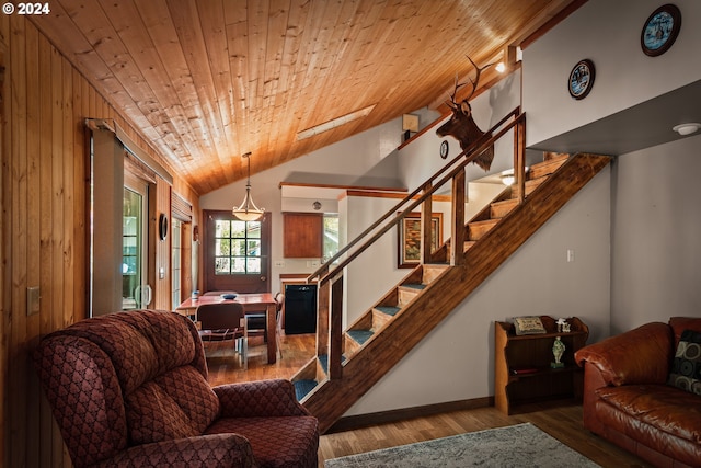 living room featuring wood ceiling, vaulted ceiling, wooden walls, and hardwood / wood-style floors