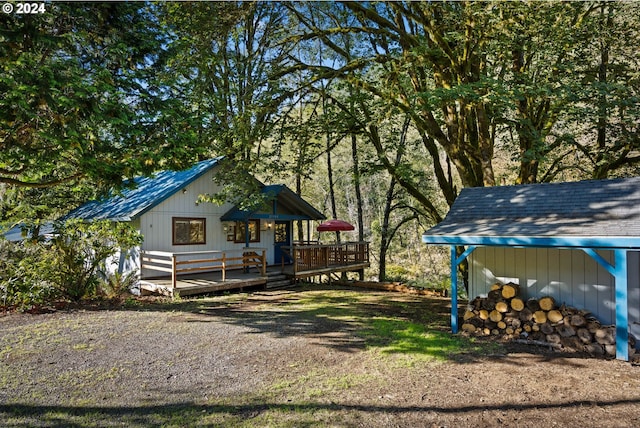 exterior space with a wooden deck and an outbuilding