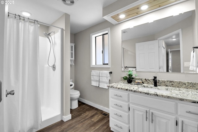 bathroom with visible vents, wood finished floors, baseboards, toilet, and a shower with shower curtain