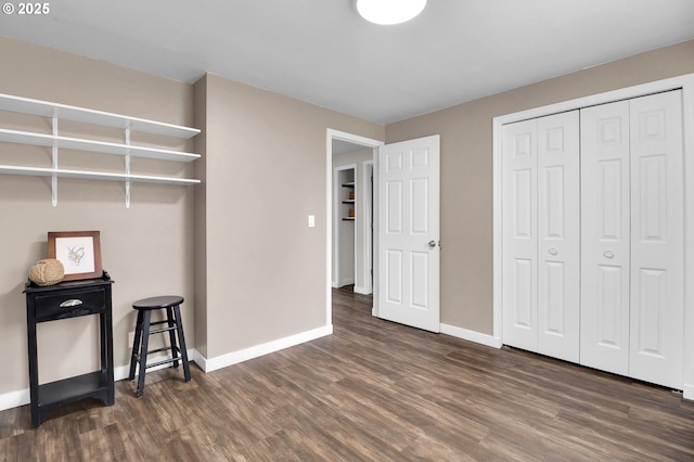 interior space with baseboards and wood finished floors