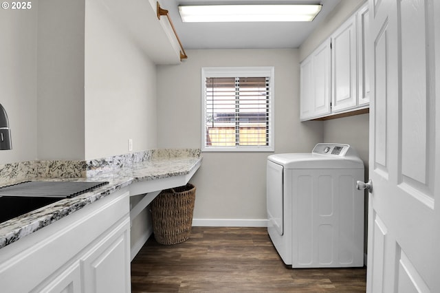 clothes washing area with baseboards, dark wood finished floors, separate washer and dryer, a sink, and cabinet space