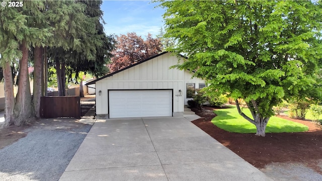 exterior space featuring a garage, fence, and driveway