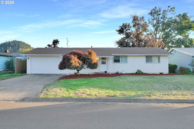 single story home with a garage and a front yard