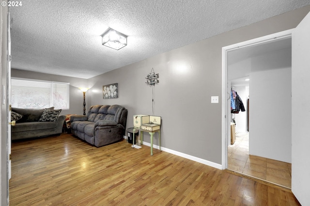 living room with hardwood / wood-style floors and a textured ceiling