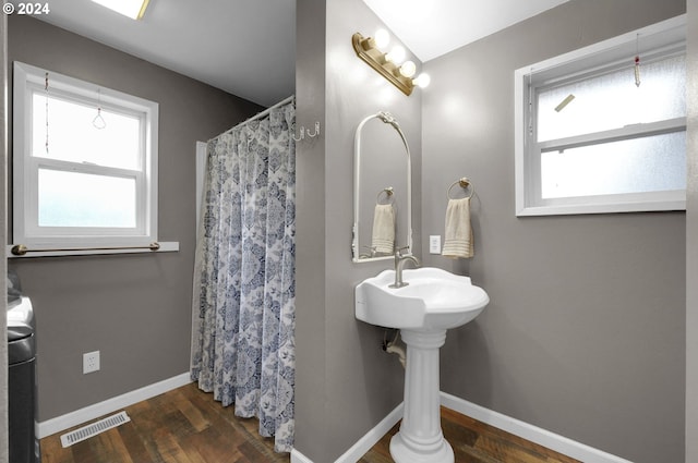 bathroom featuring wood-type flooring and a shower with shower curtain