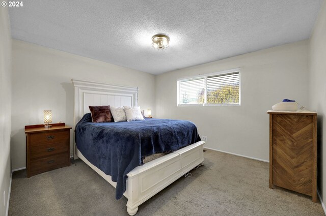 carpeted bedroom with a textured ceiling