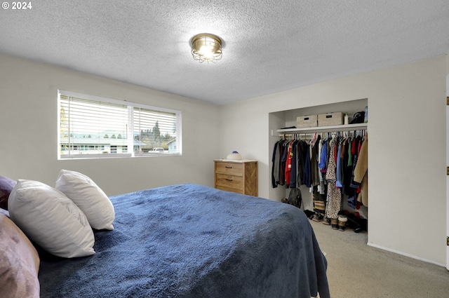 bedroom featuring carpet, a textured ceiling, and a closet