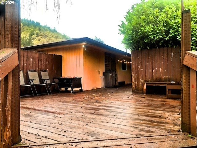 wooden terrace featuring fence