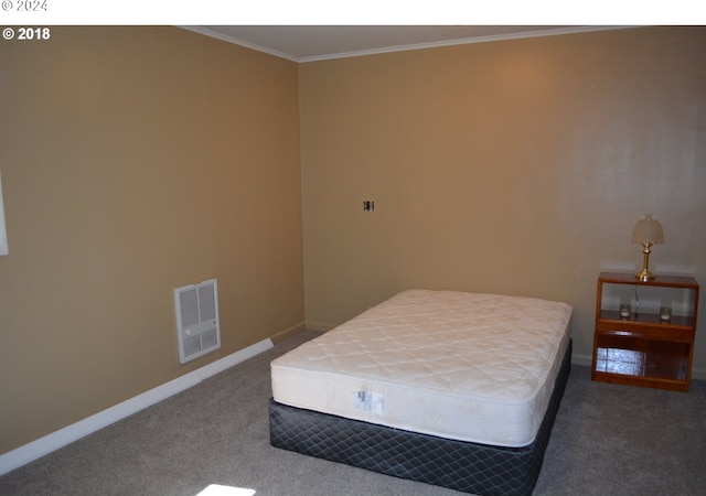 bedroom with visible vents, crown molding, baseboards, and carpet floors