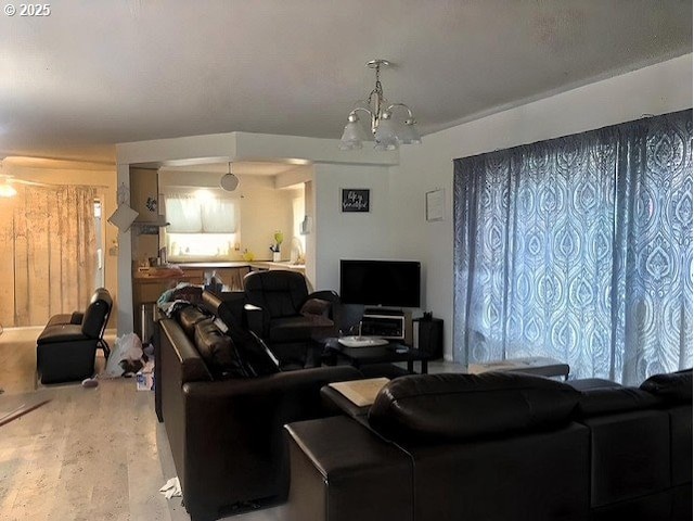 living area featuring a notable chandelier and wood finished floors