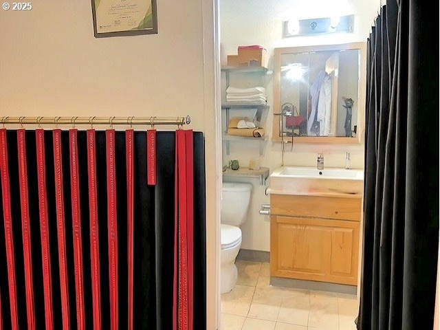 bathroom featuring tile patterned floors, toilet, and vanity