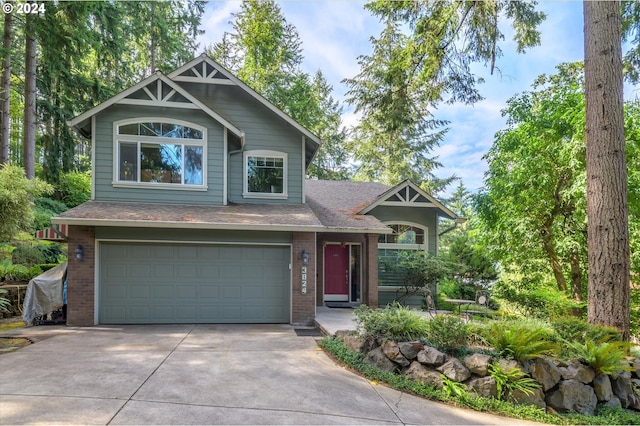 view of front of home with brick siding, concrete driveway, an attached garage, and a shingled roof