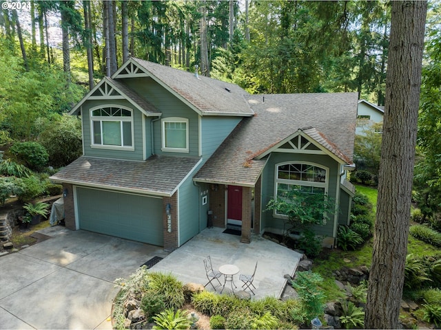 3824 Brighton Ave, Eugene, OR 97405 - view of front facade with a garage, concrete driveway, brick siding, and roof with shingles
