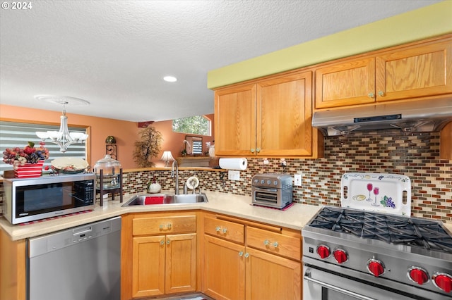 3824 Brighton Ave, Eugene, OR 97405 - kitchen featuring stainless steel appliances, under cabinet range hood, a sink, light countertops, and a textured ceiling