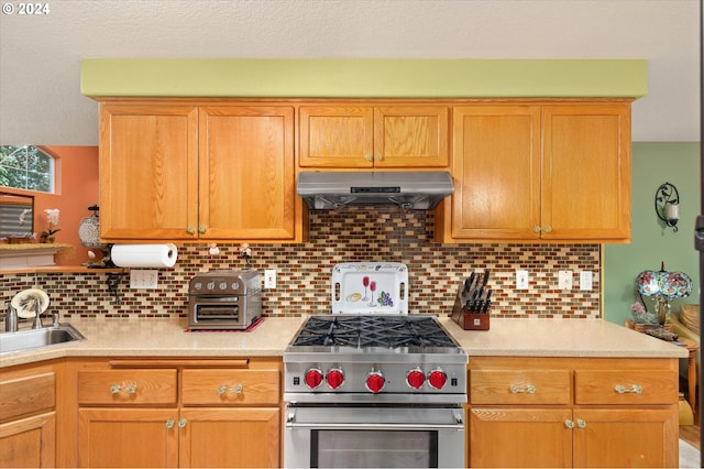 3824 Brighton Ave, Eugene, OR 97405 - kitchen featuring high end stainless steel range oven, under cabinet range hood, a sink, light countertops, and a textured ceiling