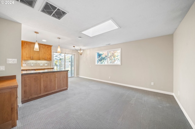 kitchen with carpet flooring, hanging light fixtures, and a notable chandelier