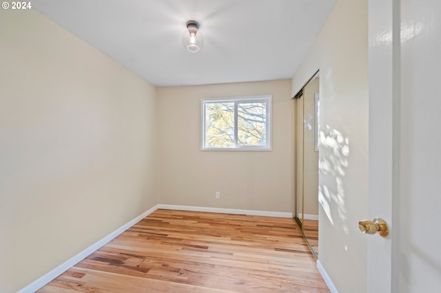 unfurnished room with light wood-type flooring