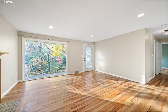 unfurnished living room with light hardwood / wood-style flooring