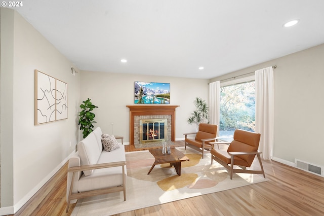 living area featuring a fireplace and light wood-type flooring