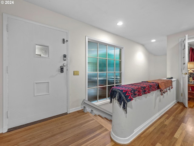 bedroom with recessed lighting, wood finished floors, and baseboards