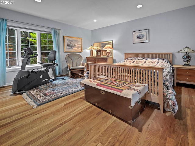 bedroom with wood finished floors and recessed lighting